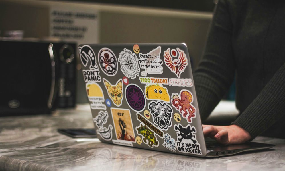 Collection Of Stickers On Laptop Computer