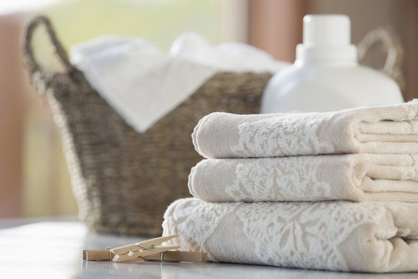 Folded towels with wicker basket and softener