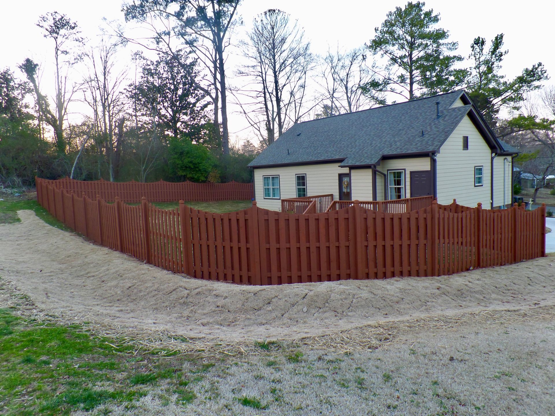 A house with a wooden fence around it