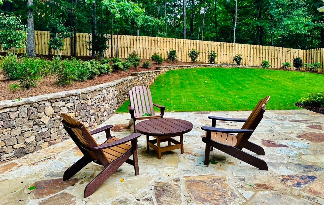 There are two chairs and a table on the patio.