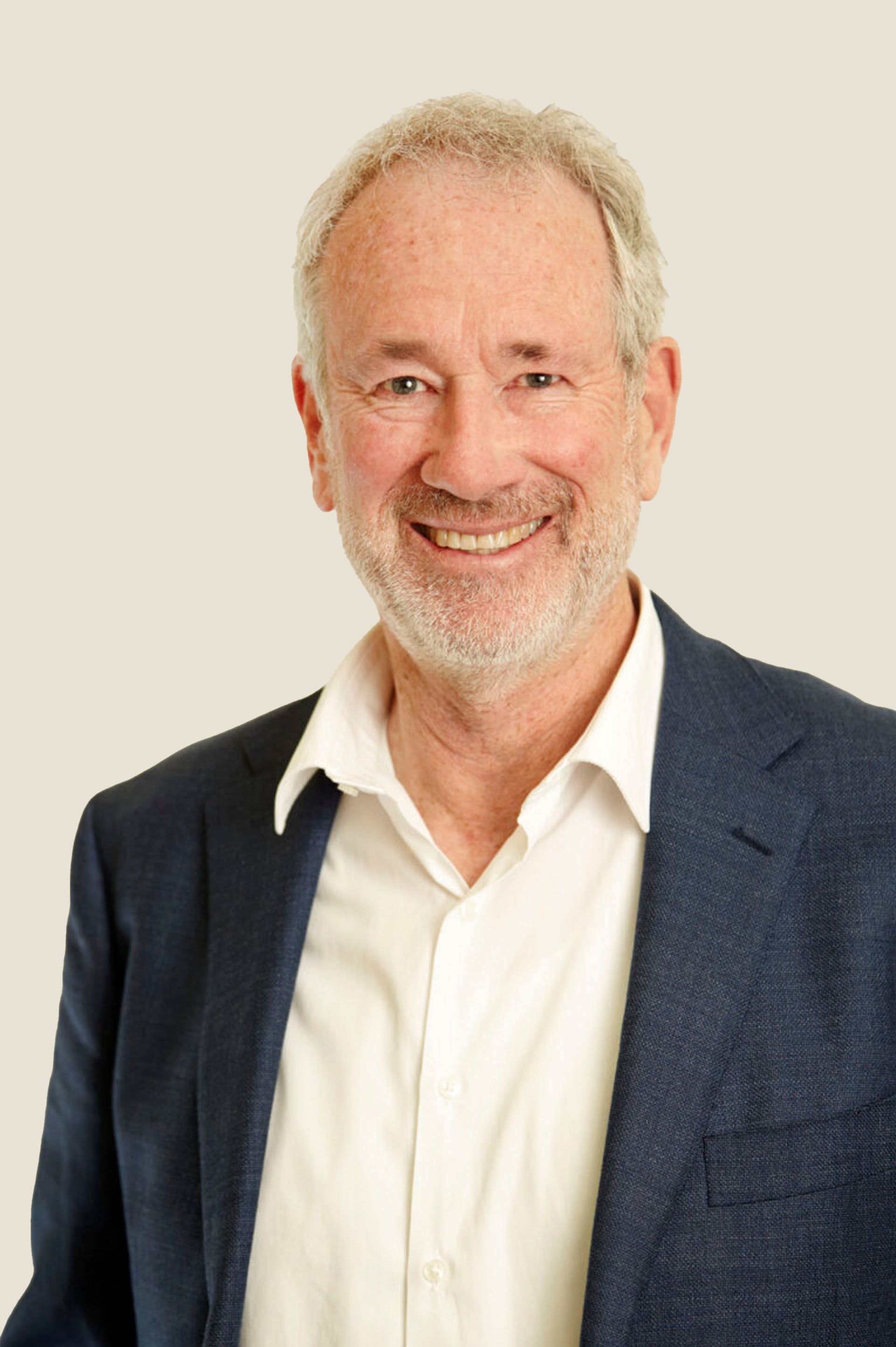 A man in a suit and tie is smiling for the camera.