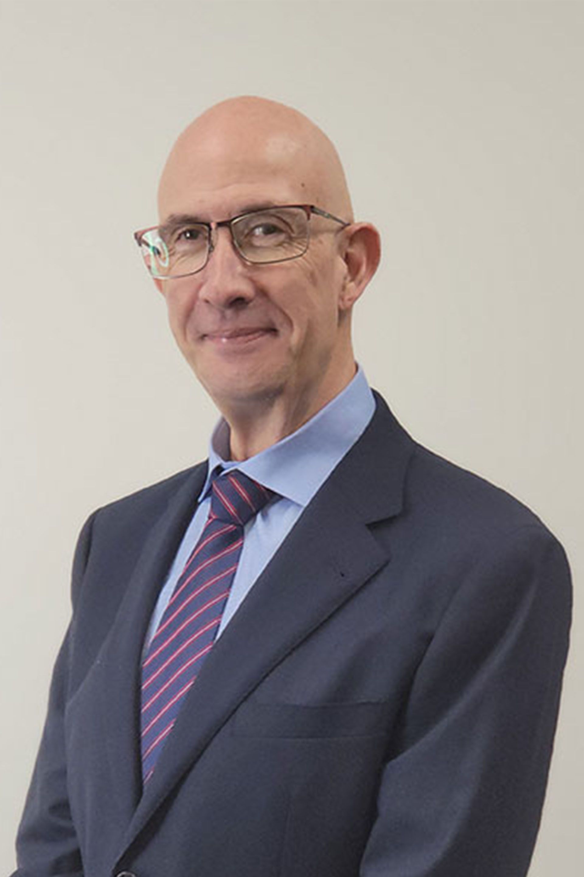 A man in a suit and tie is smiling for the camera.