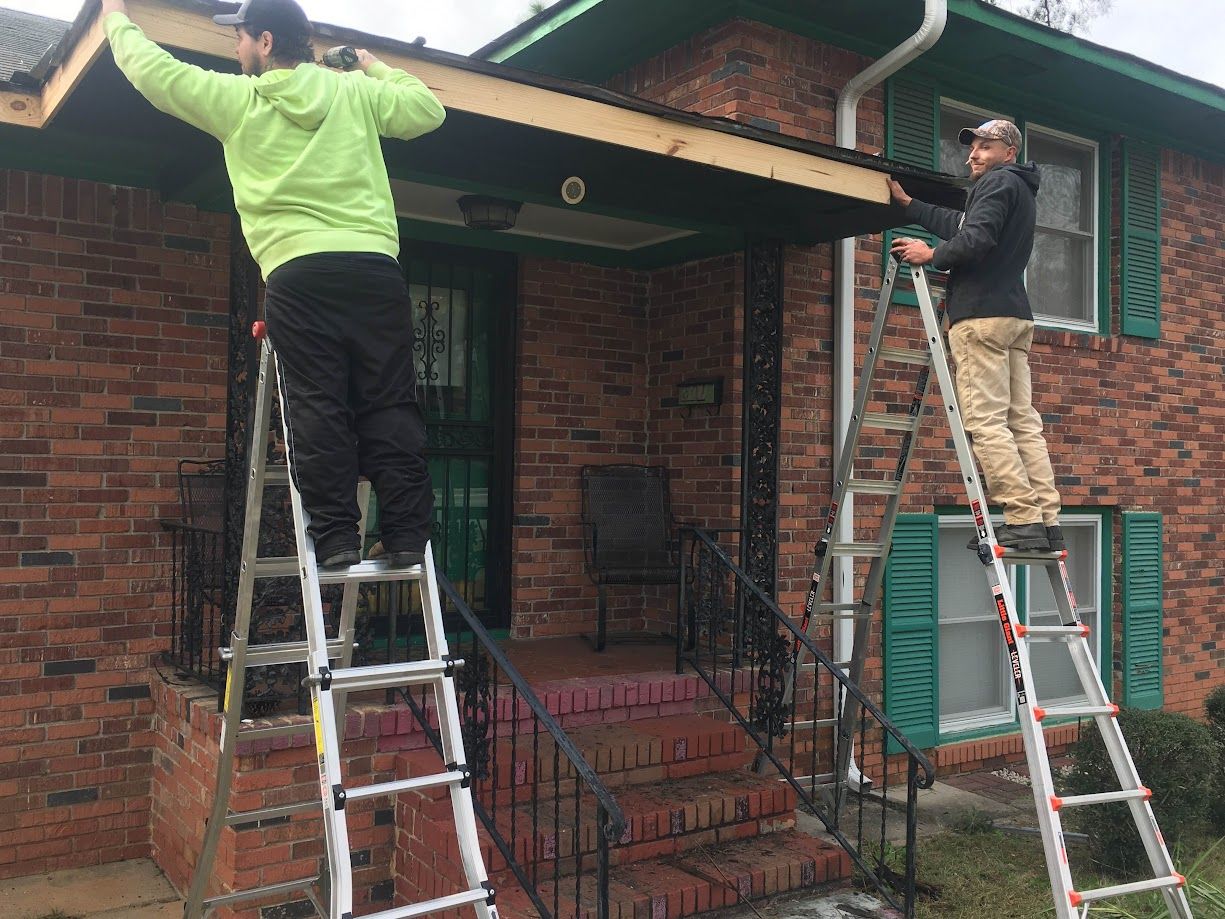 Professional contractor fixing a soffit and fascia.