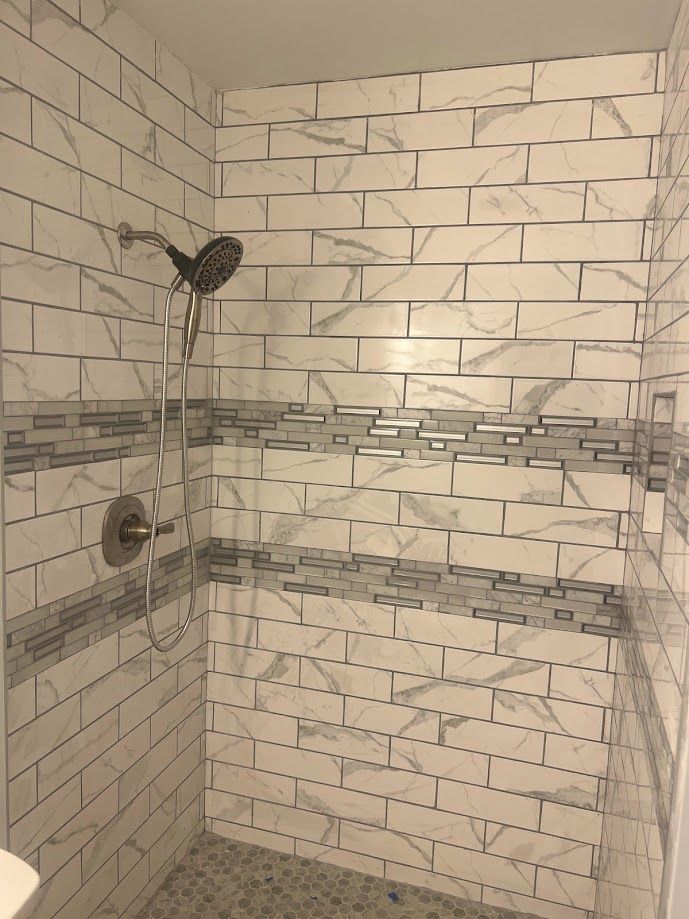 Professional contractor tiles bathroom.