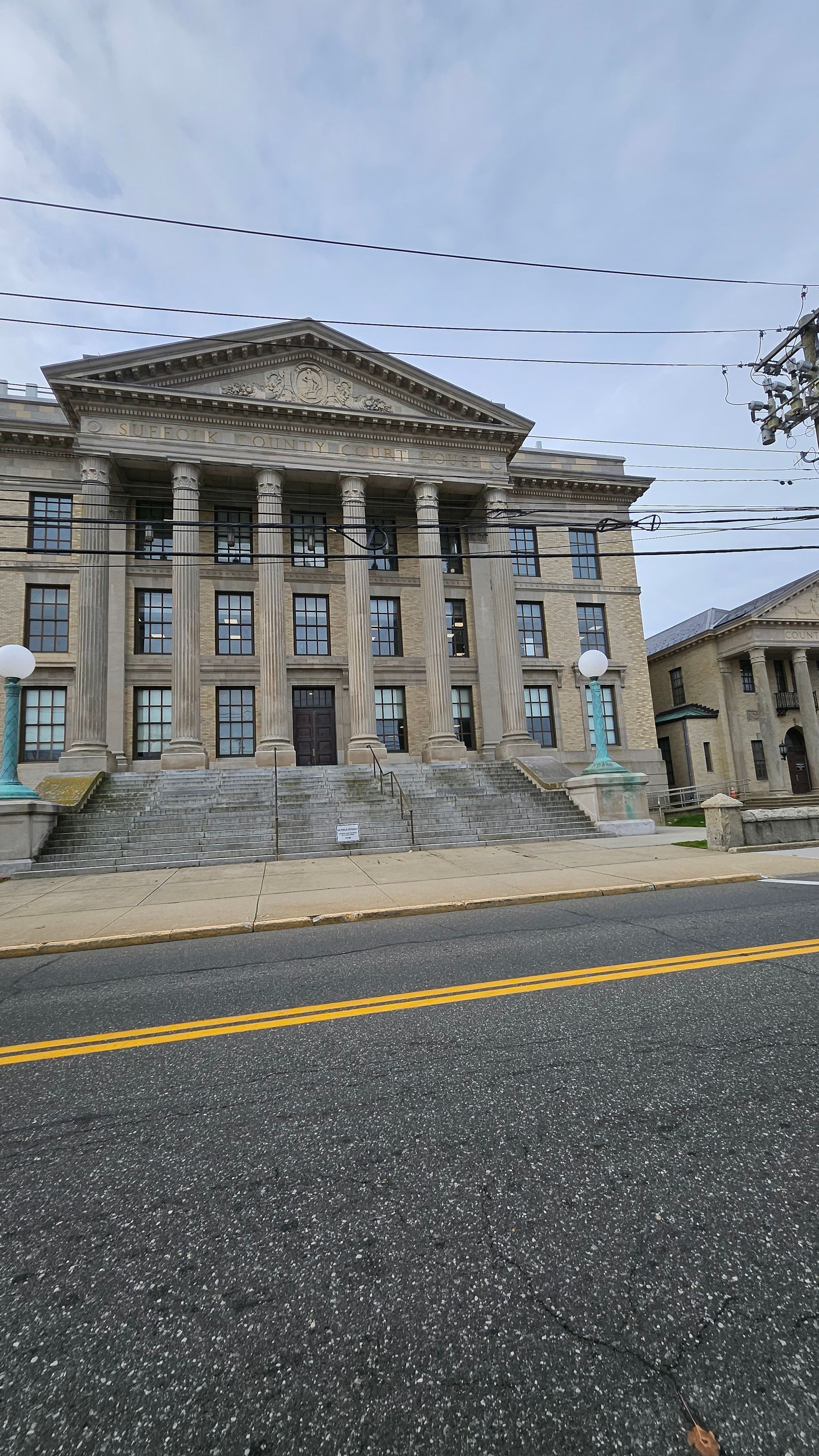 A judge holding a gavel at a desk with law documents and scales of justice in the background.
