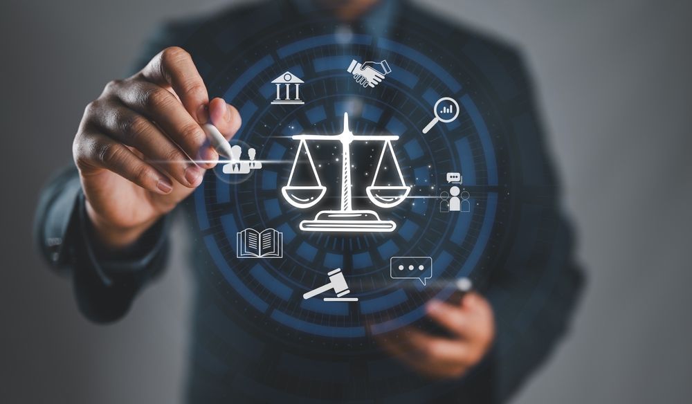 Man pointing pen at digital scales of justice icon surrounded by related symbols.