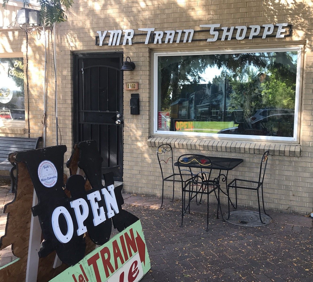 A brick building with an open sign in front of it