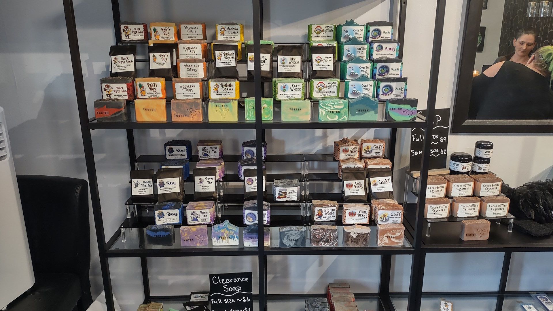 A shelf filled with lots of different colored boxes.