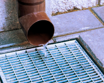 Cuatro obreros de la construcción en un tejado, trabajando en un edificio. Uno en una escalera, los demás con herramientas.