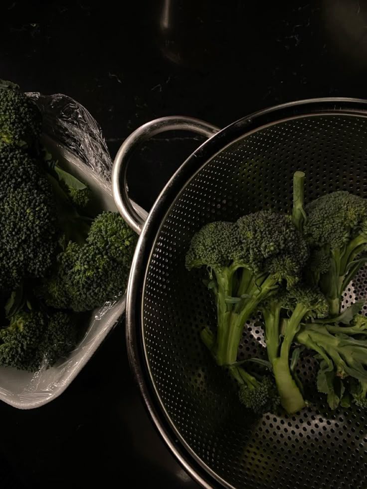 A bottle of almond milk is sitting on a table next to almonds.