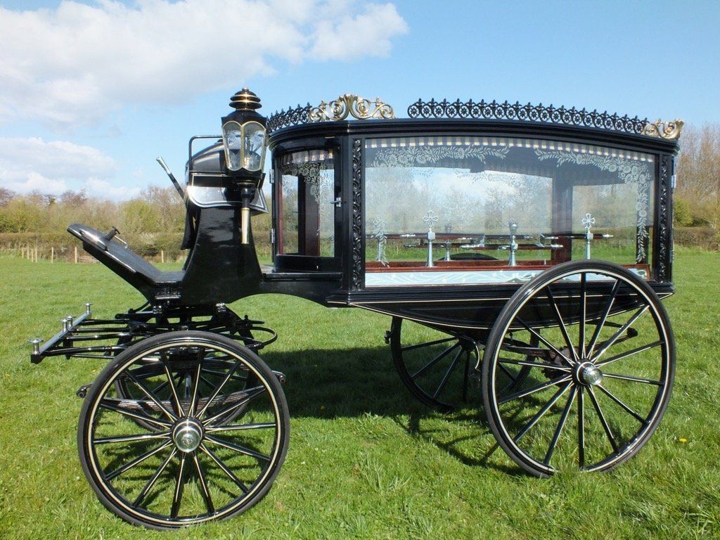 Black hearse for horse drawn funeral service