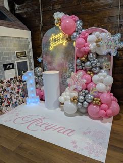 Hallway with balloon arch and colorful decorations.