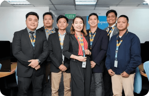 A diverse group of professionals in business attire smiling for a group photo.