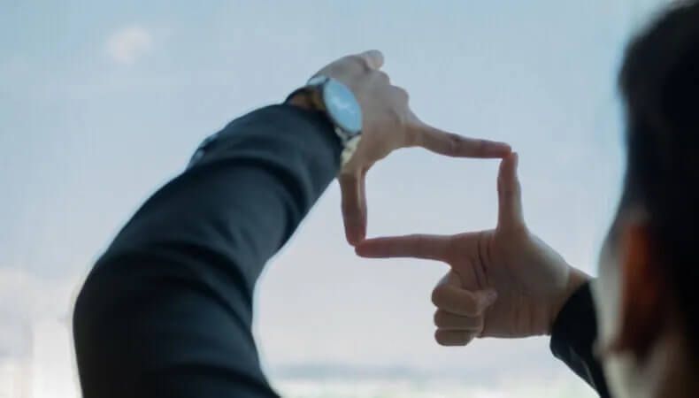 Hands forming square shape, representing innovation or capturing a moment.