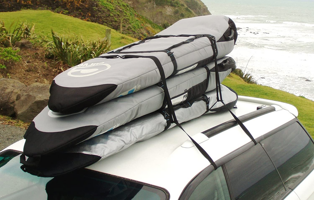 A stack of surfboards on top of a car