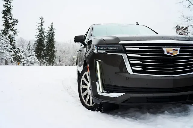 Black SUV in mountain snow