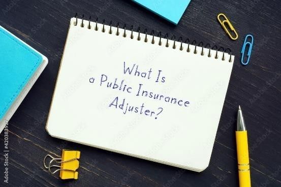 A notebook with the words what is a public insurance adjuster written on it