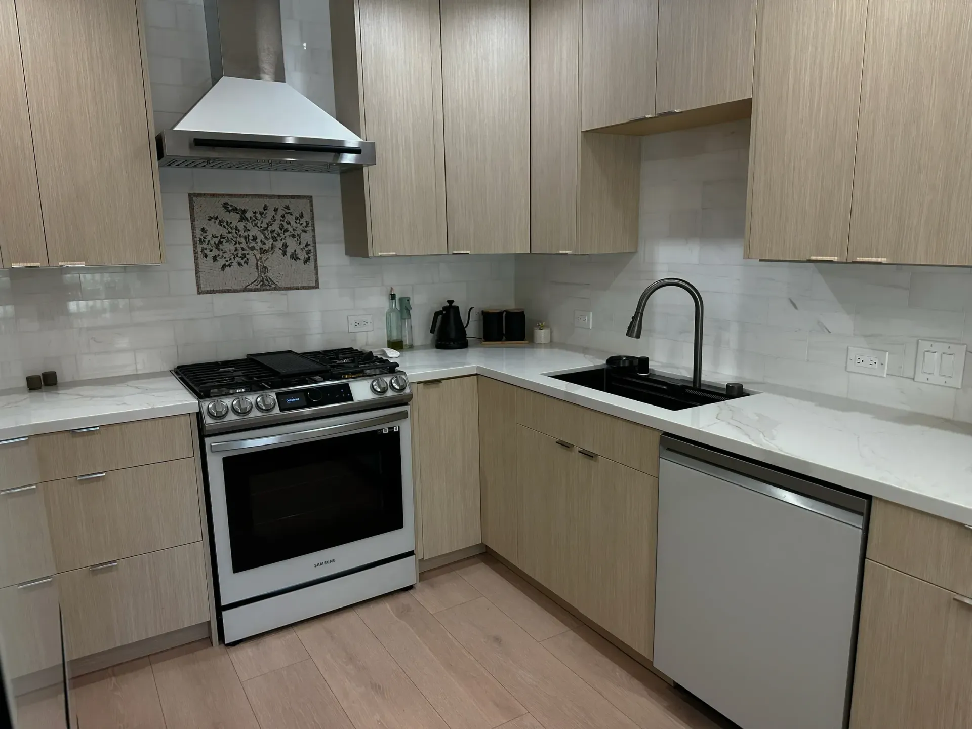 A kitchen with a stove top oven and a sink
