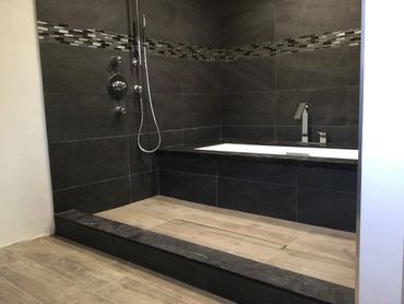 A bathroom with a bathtub and a shower.