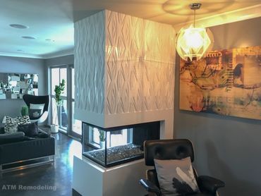 A living room with a fireplace and a chair.