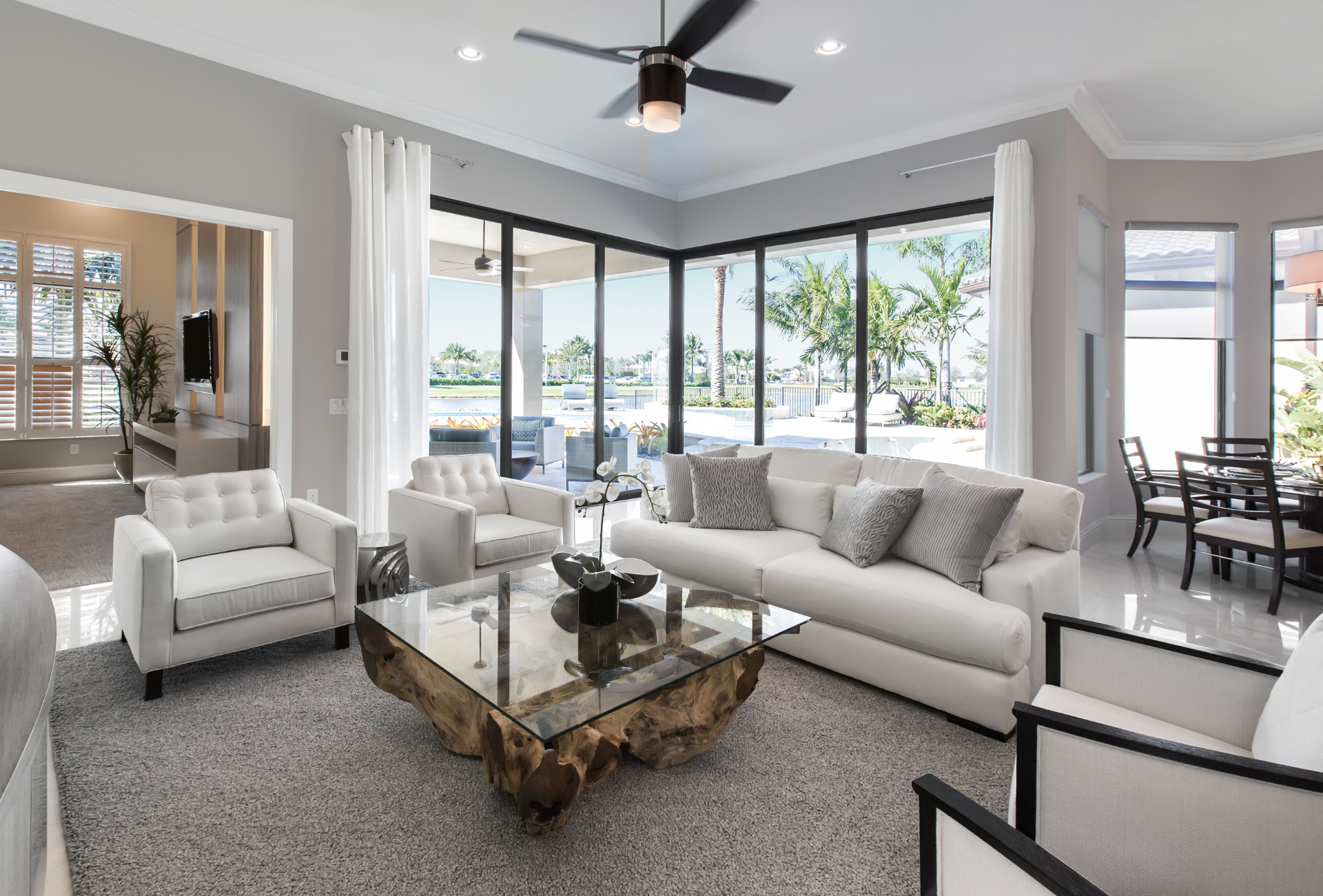 A shower with marble tiles and a bench in it.
