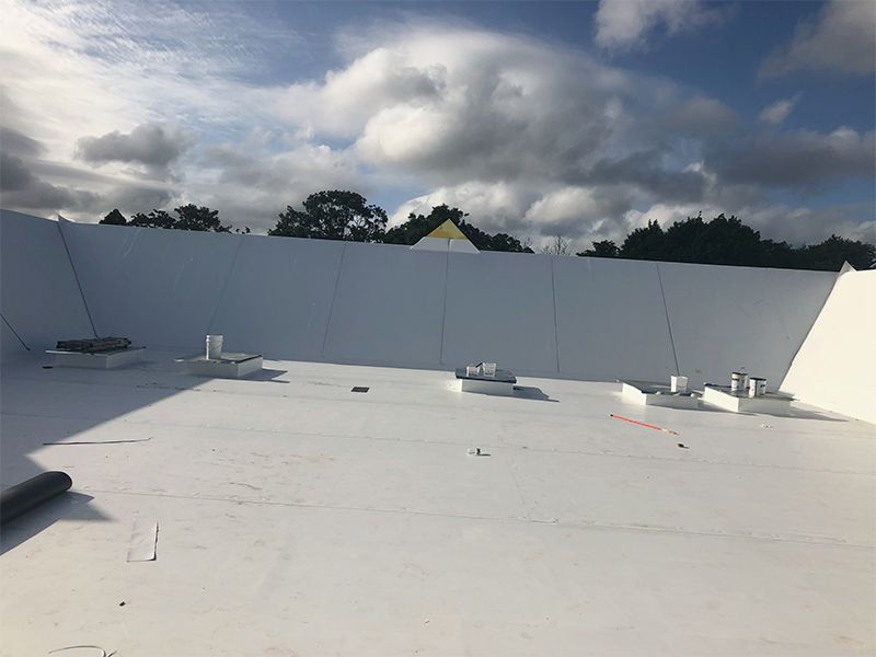 A white roof with a blue sky in the background.