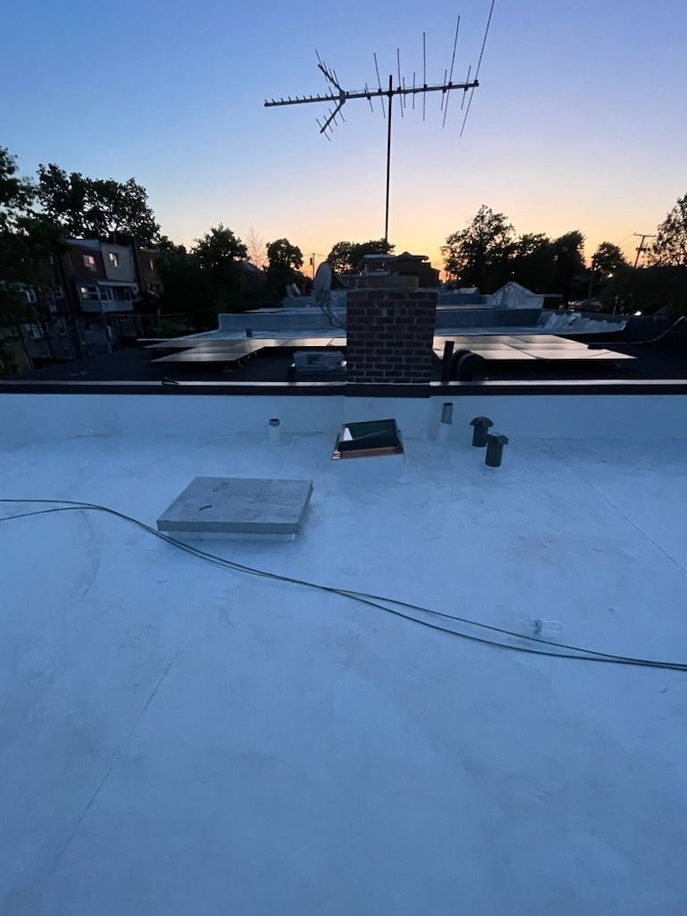 A white roof with an antenna on top of it