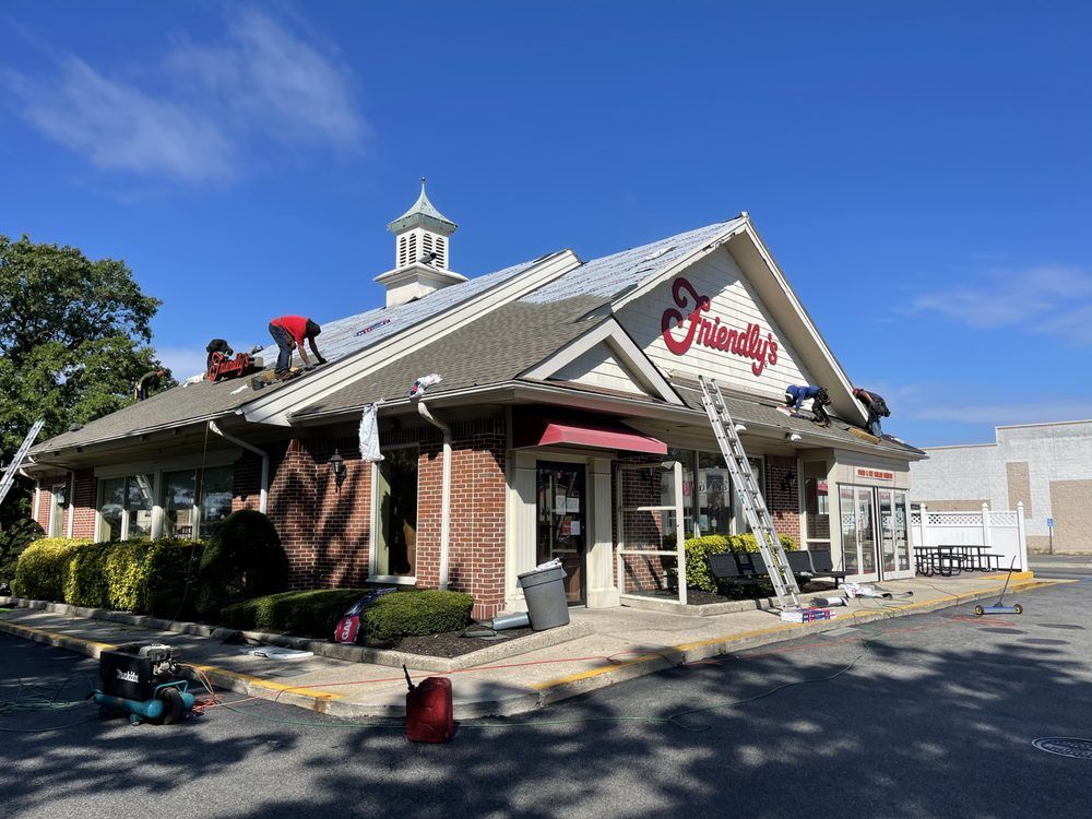 A group of people are working on the roof of a building.