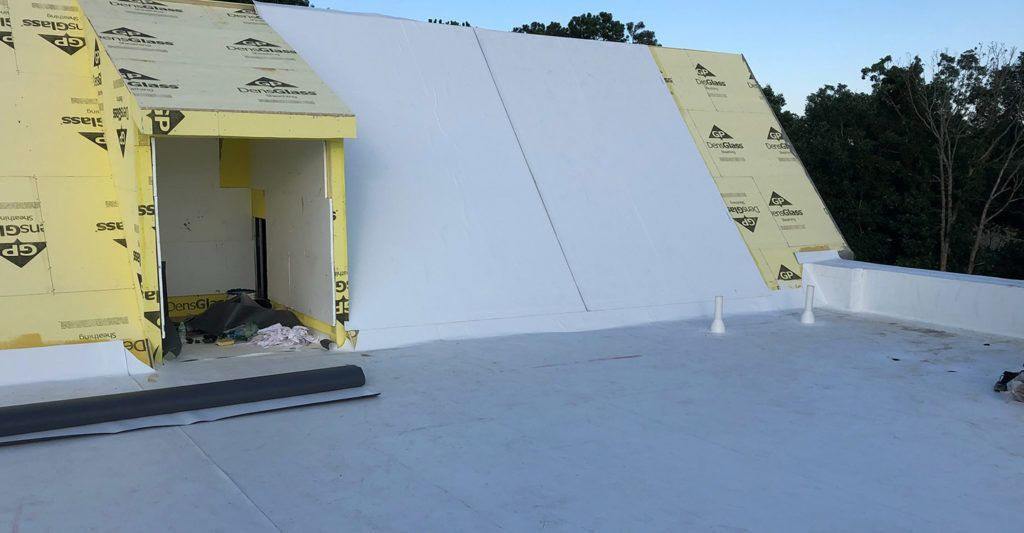 A white roof is being installed on top of a building.