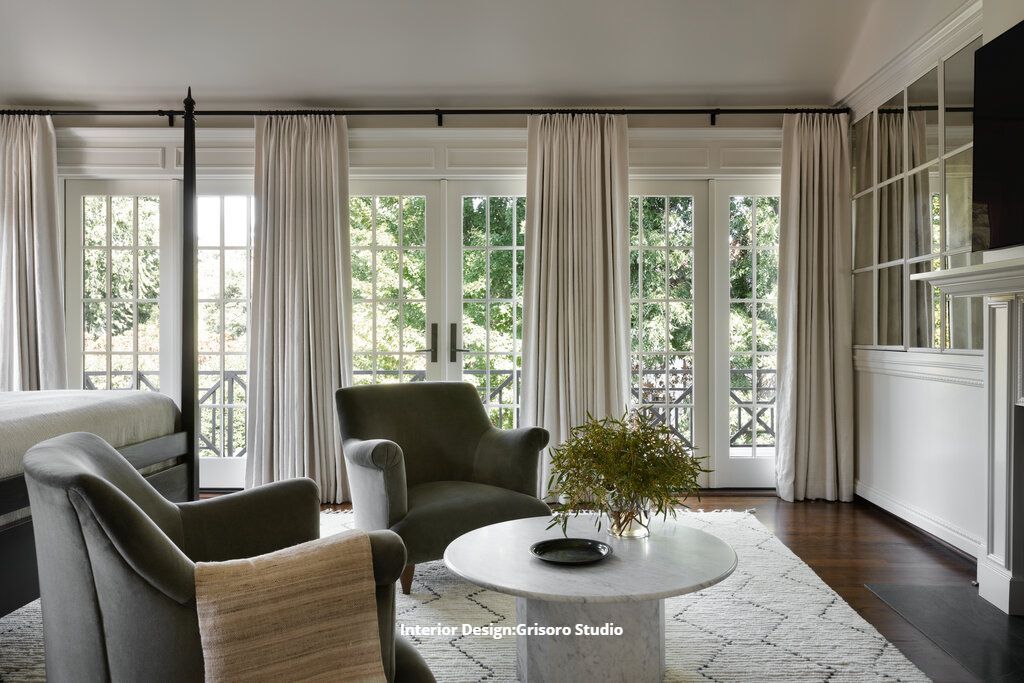 A beautiful living area in a Fort Worth bedroom with a coffee table , chairs , and a fireplace.