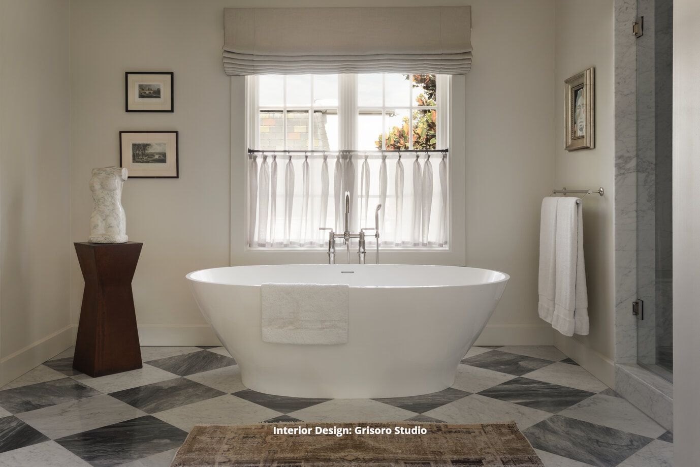 A luxurious bathroom with a bathtub and a checkered marble tile floor