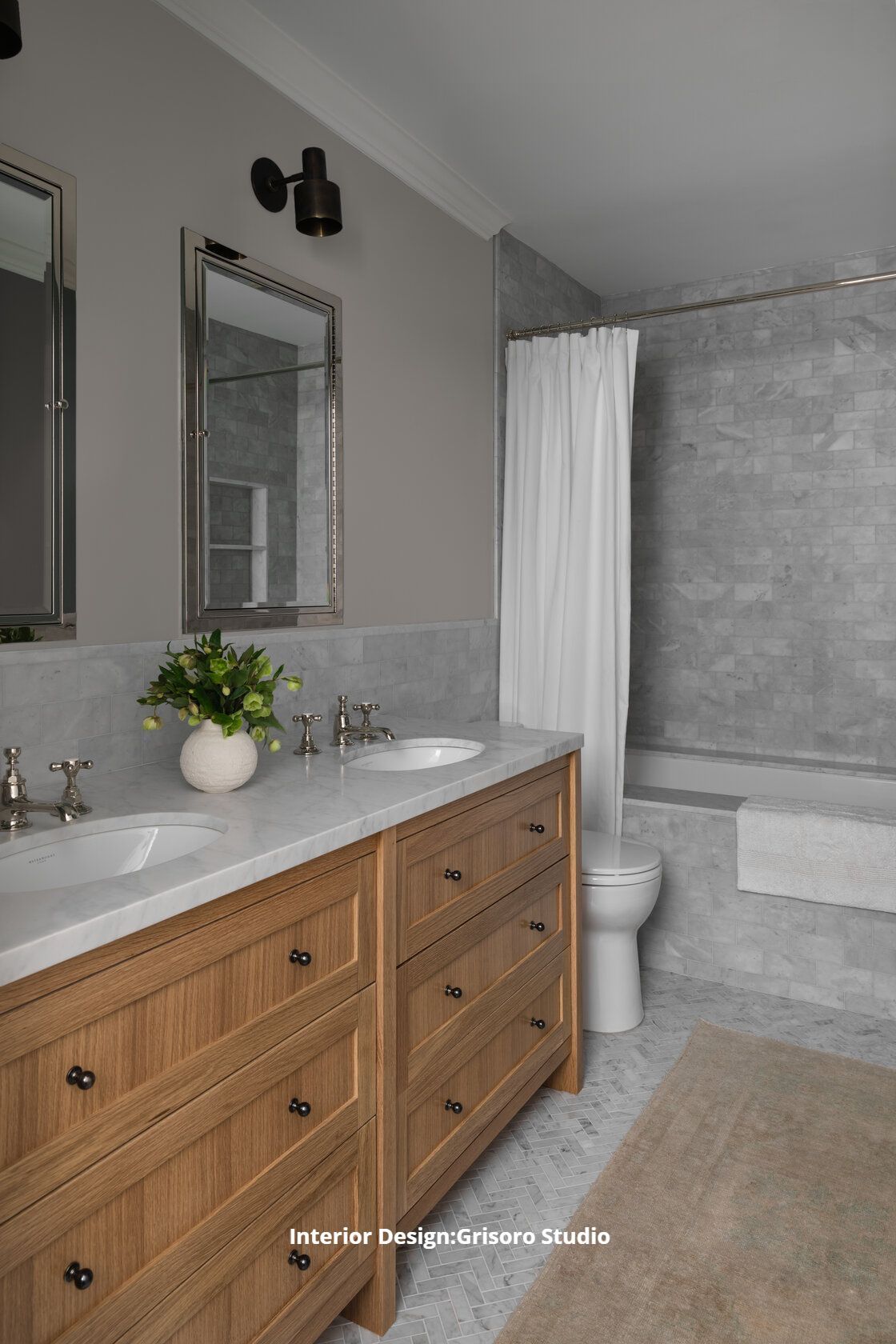 A bathroom with two sinks , a toilet , and a bathtub.