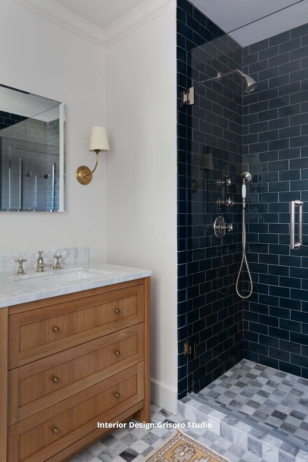 A custom bathroom with a sink , mirror and walk in subway tile shower.