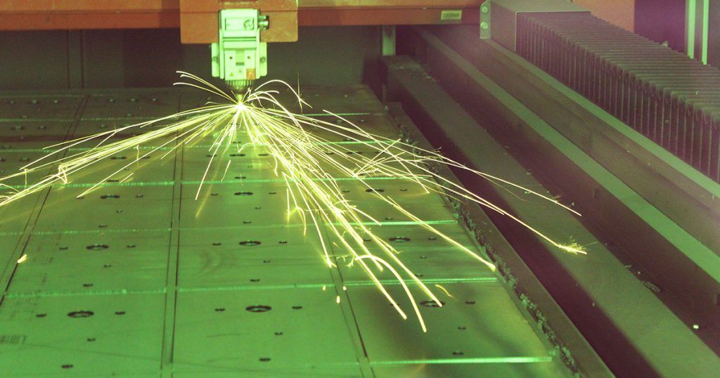 Our Bystronic laser programmed to cut metal in a specific pattern