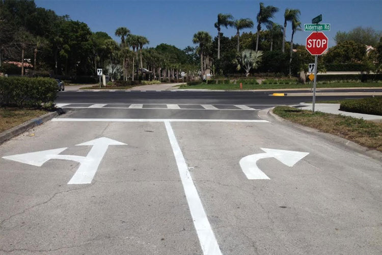 A stop sign is painted on the side of the road