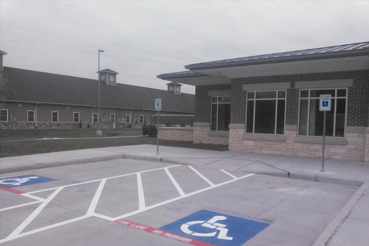 A handicapped parking spot in front of a building