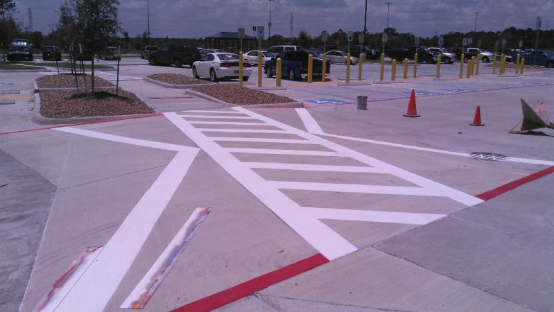 A parking lot with white stripes and red lines