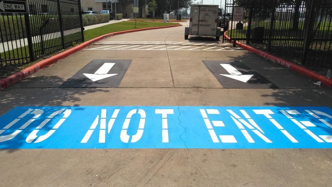 A do not enter sign is painted on the sidewalk