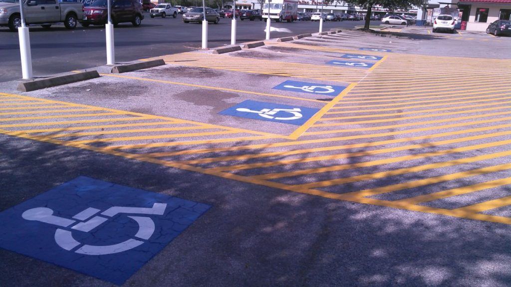 A handicapped parking spot in a parking lot