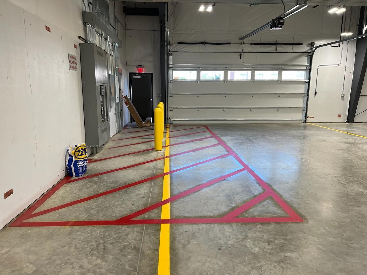 A garage with a handicapped parking space and a yellow line on the floor.