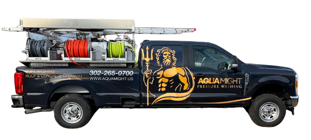 Dark blue pressure washing truck with gold logo and equipment in bed.