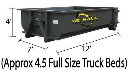 A dark gray dumpster labeled 