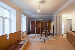 Interior room under renovation; materials and ladder present.