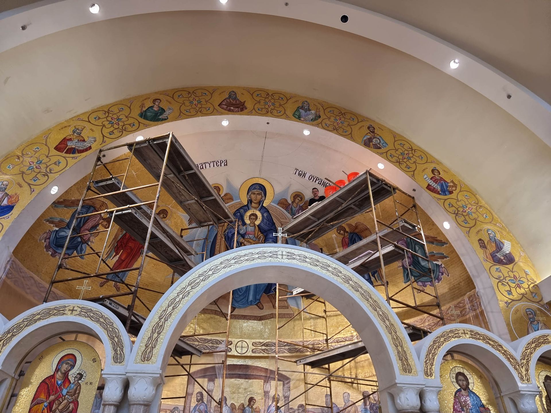 Byzantine mosaic installation with scaffolding. Artisans creating Platytera of the Theotokos in Apse of an Orthodox church