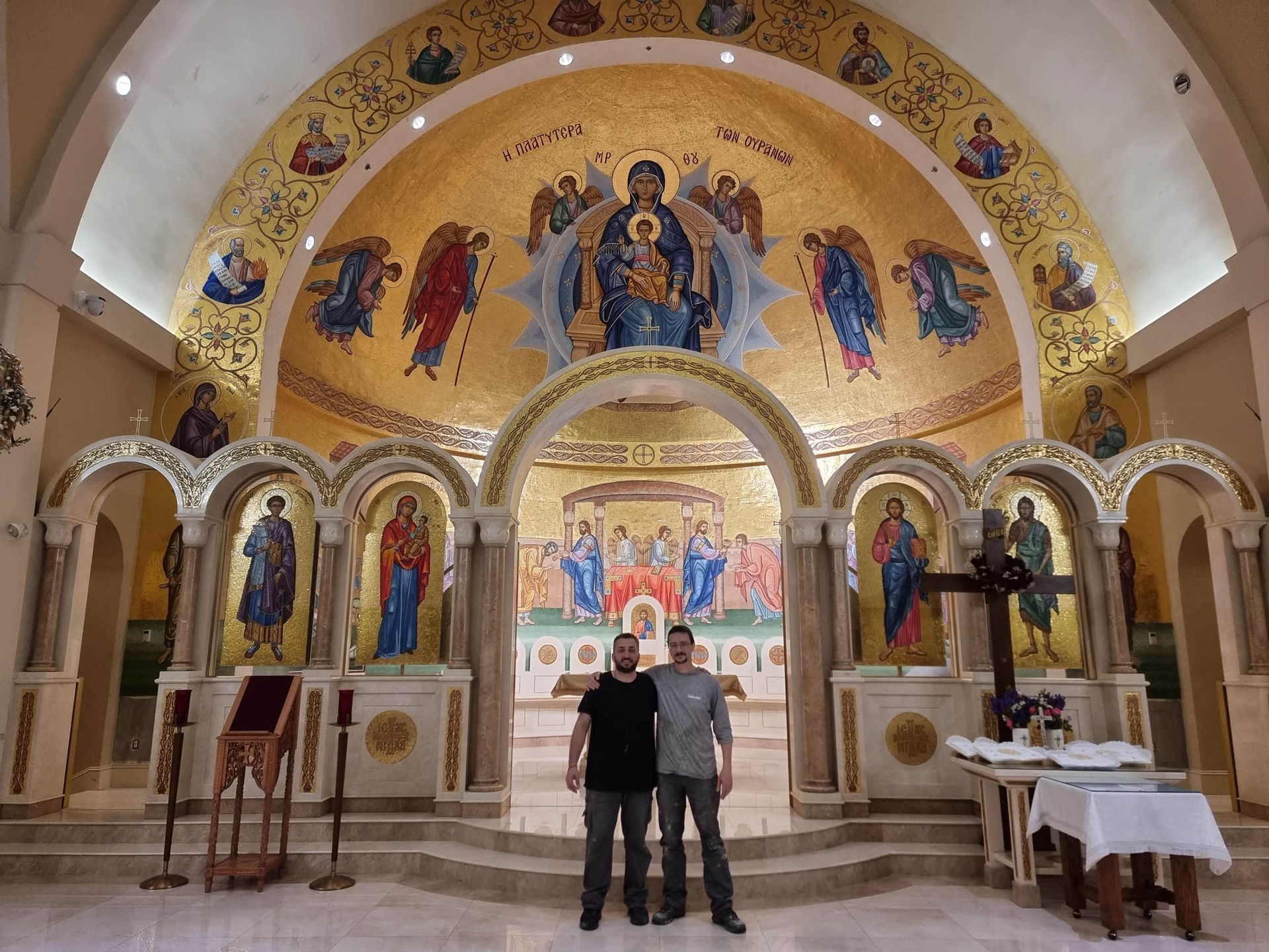 Greek mosaic artisans Stamatis and Vasilis before completed Platytera mosaic installation in St Demetrios Church in Weston MA