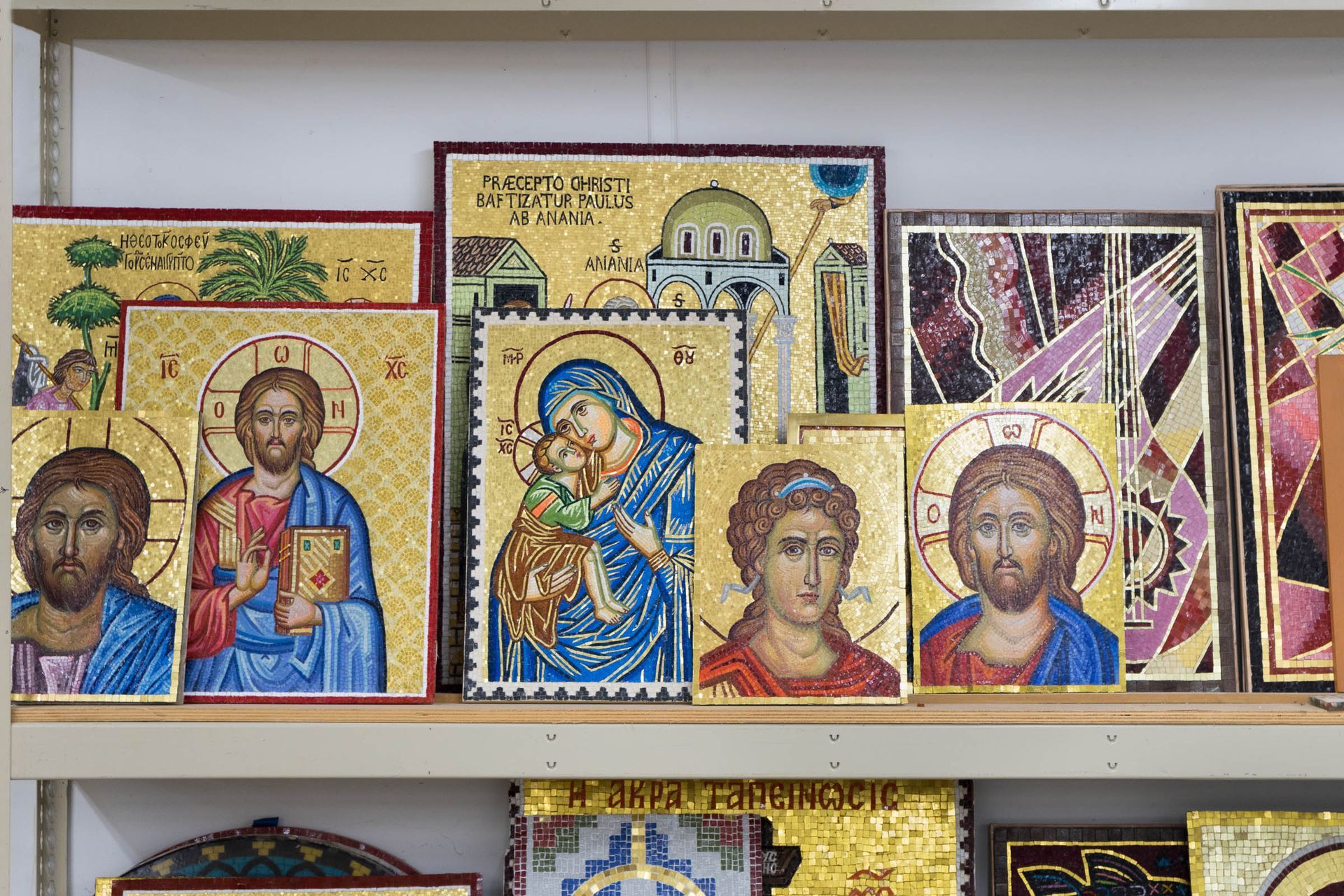 Handmade portable Byzantine mosaics on studio shelf. Custom commissioned church icon panels and liturgical art in smalti tile