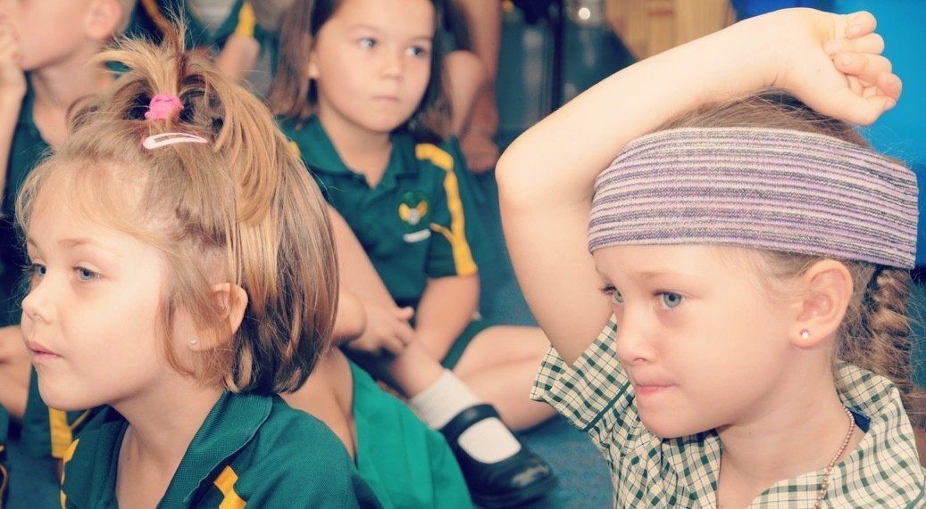 St Joseph's Catholic Primary School kids with hands in air
