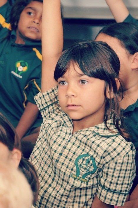 St Joseph's Catholic Primary School student with her hand in the air