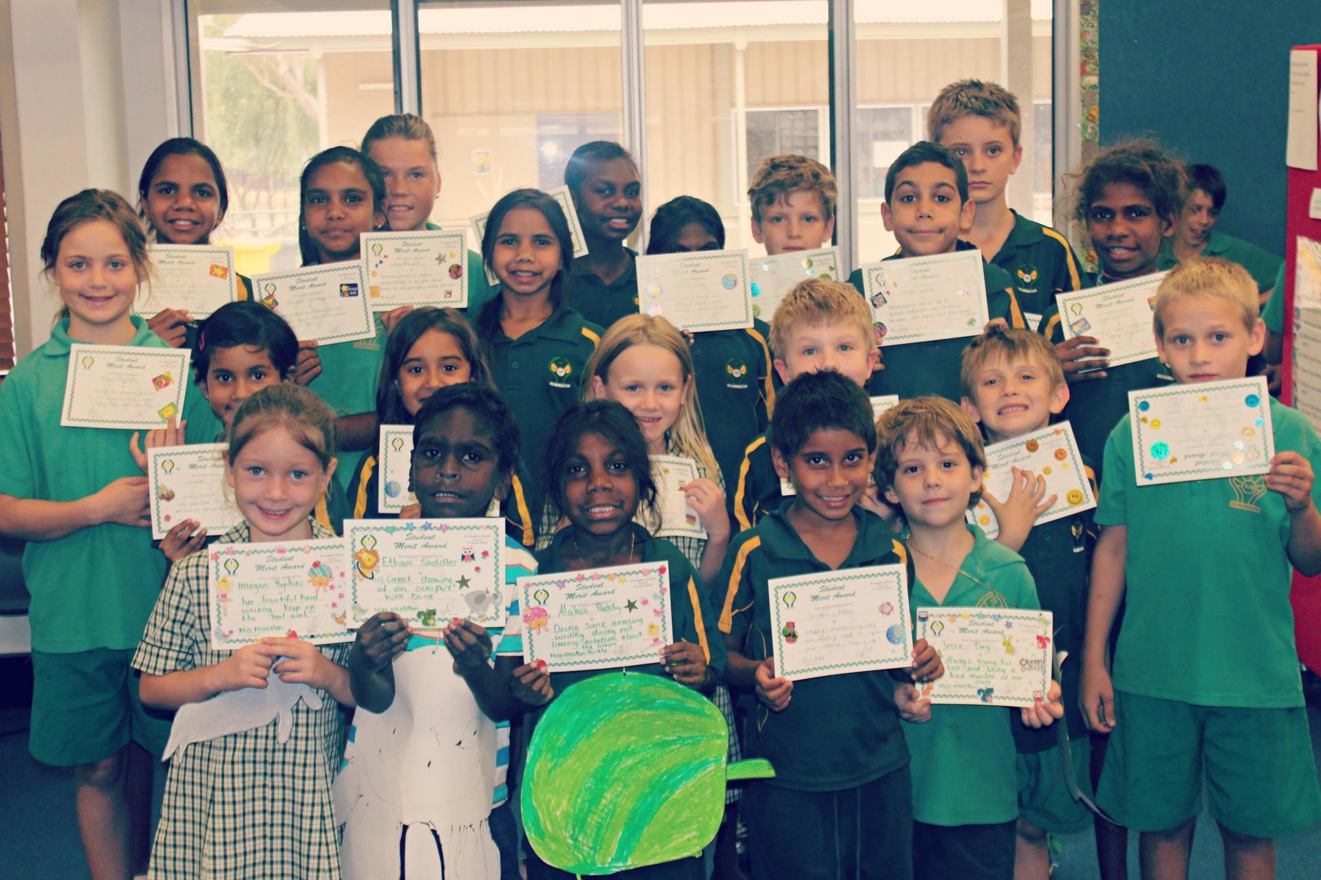 St Joseph's Catholic Primary School kids collecting merit certificates