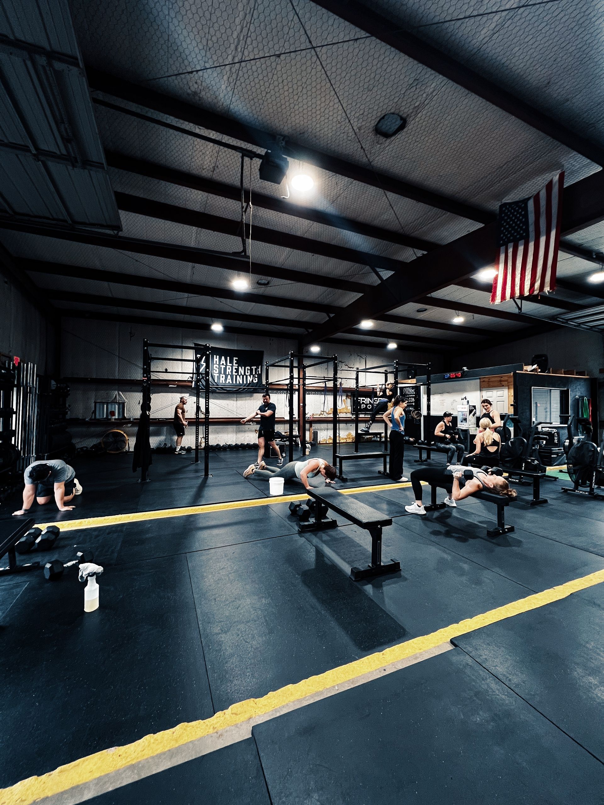 A group of people are doing exercises in a gym.